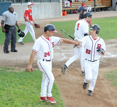 : Dan Huber (24) and Shawn Larson (22) were among a number of Tigers who were busy rounding bases and scoring runs during the first two innings of Belle Plaine’s 11-1 trouncing of Chanhassen Friday night in Chanhassen. The Tigers scored five runs in the first inning and four more in the second. [PHOTO COURTESY BELLE PLAINE HERALD]