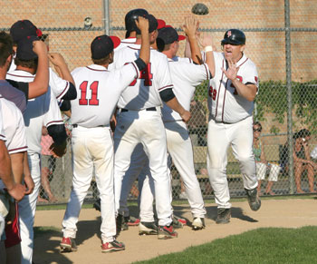 The Tigers’ Jeff Miller is congratulated by teammates after his three-run home run in the top of the eighth-inning was the difference-maker in Saturday’s 5-2 victory over Marshall.