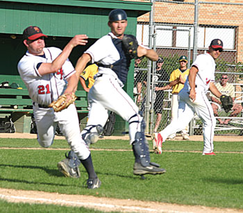 Belle Plaine pitcher Shane Hofmann fielded the ball and tossed to first base during Saturday’s 5-2 victory over Marshall in the Tigertown Classic. Also pictured is catcher Pat Schultz.